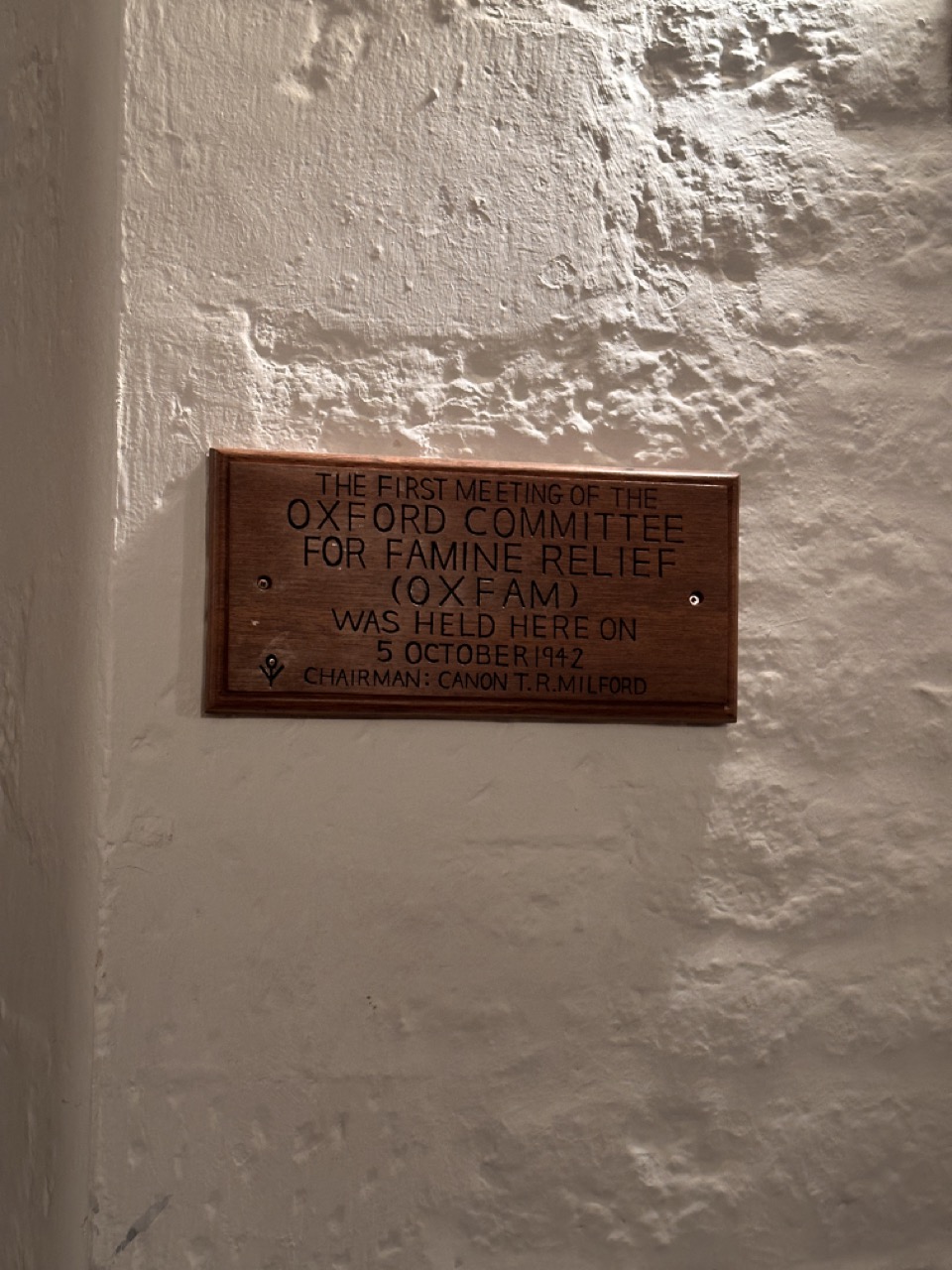 Wooden plaque recording the first meeting of the Oxford Committee for Famine Relief on 5 October 1942, chaired by Canon T. R. Milford.